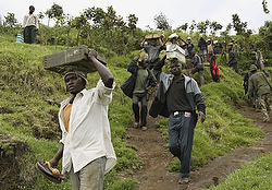 MEN CARRY BOXES OF AMMUNITION FOR REBEL FIGHTERS DURING WITHDRAWAL IN CONGO